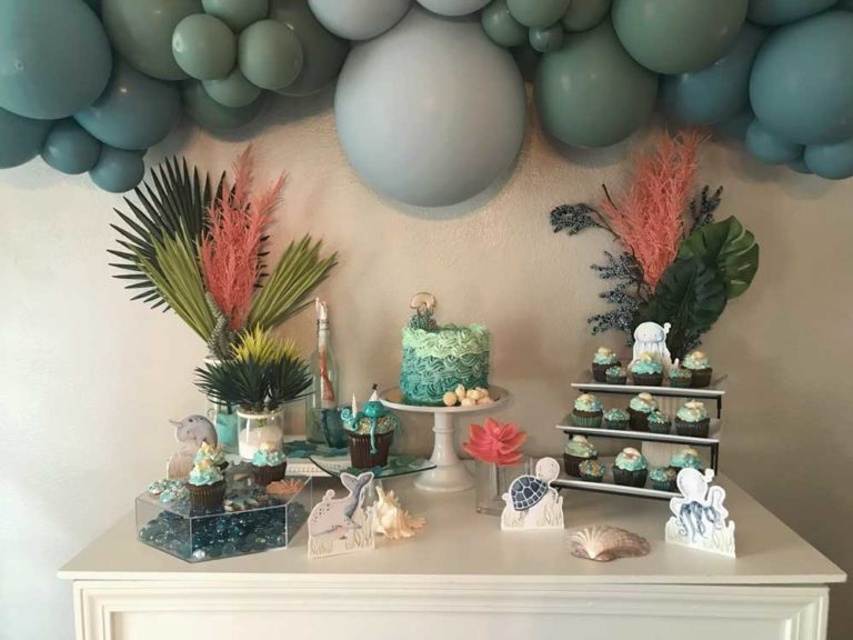 UNDER THE SEA THEMED DESSERT TABLE STAGED WITH DECOR AND DESSERTS